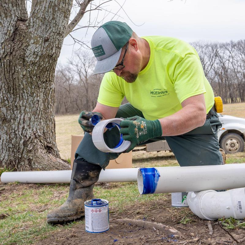 McElroy's residential service plumber connects pipes for a sewer line replacement.