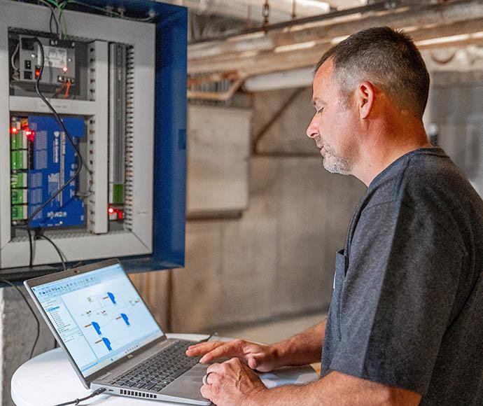 Keith Watkins programs a building controls system.