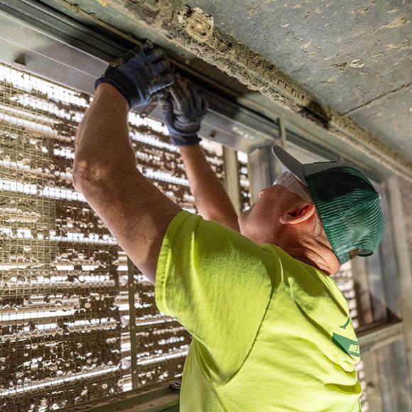 McElroy's tech performing damper inspection