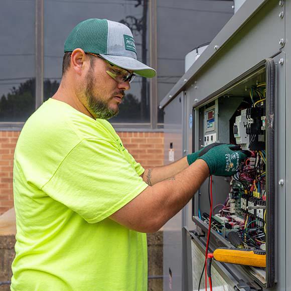 McElroy's technician checking connections in a chiller.