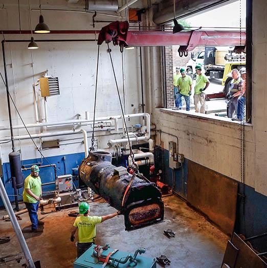 McElroy’s used a rotating boom crane to remove an outdated chiller from a hard-to-access basement at the Docking building.