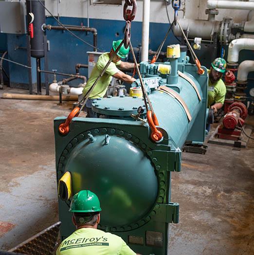 McElroy’s used an innovative crane technique to lower a new chiller into the hard-to-access Docking state office basement.