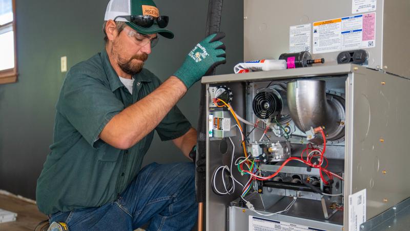 McElroy's technician installs a new furnace as part of an HVAC system update.