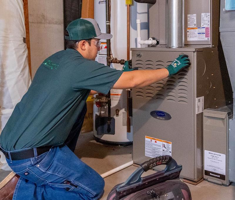 McElroy's technician works on Carrier furnace.