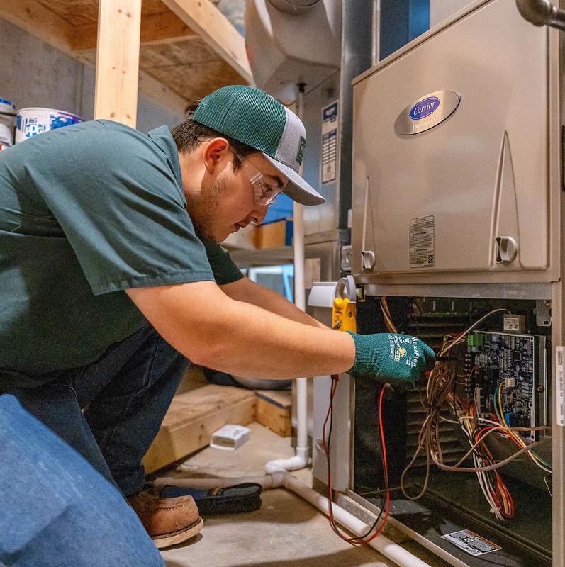 McElroy's technician works on Carrier furnace.