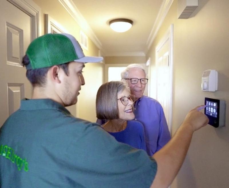 McElroy's technician demonstrates smart thermostat usage.