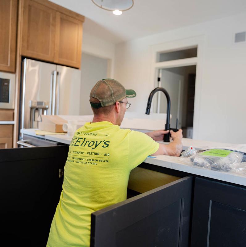 McElroy's plumber installs new kitchen faucet.