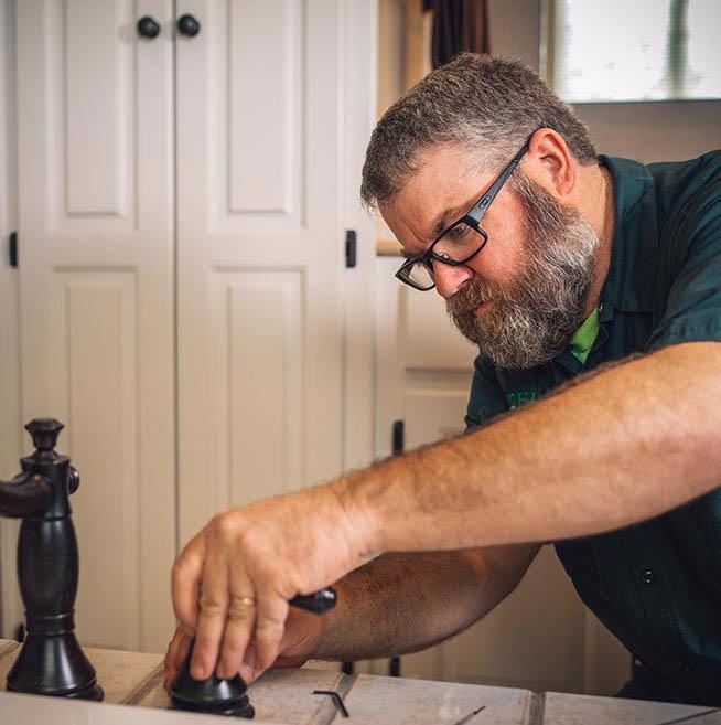 McElroy's plumber installs new bathroom sink fixtures.