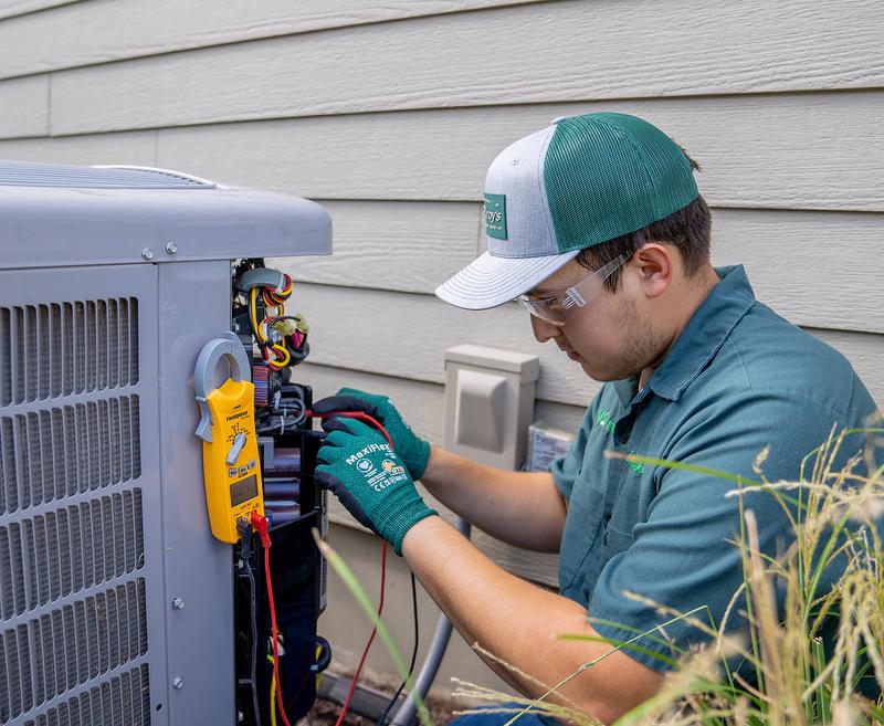 McElroy's HVAC technician works on repairing an outdoor a/c unit.