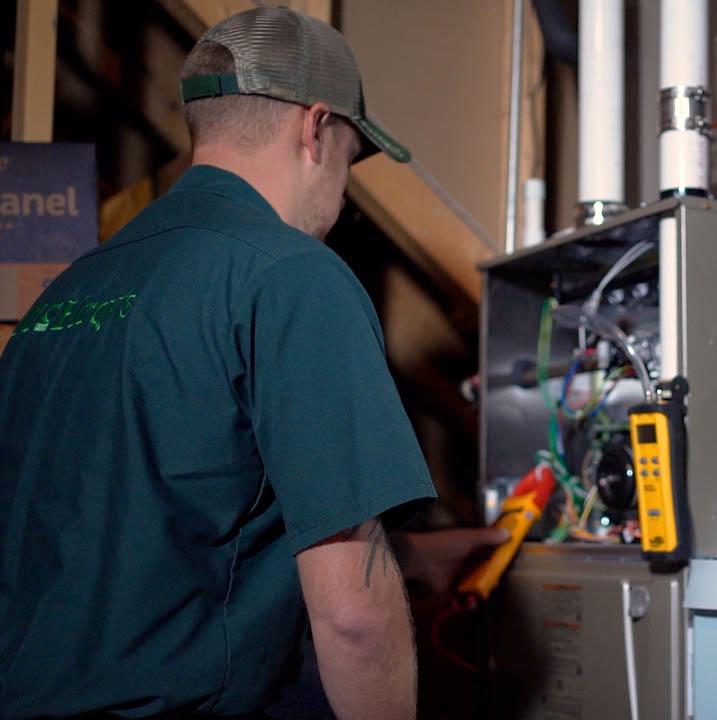 McElroy's HVAC technician applies diagnostic tools to a residential furnace.