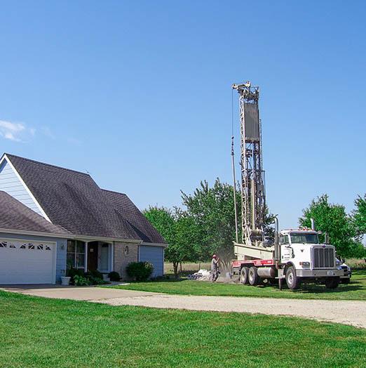 The drilling process for the installation of the underground pipes for a geothermal heat pump system.