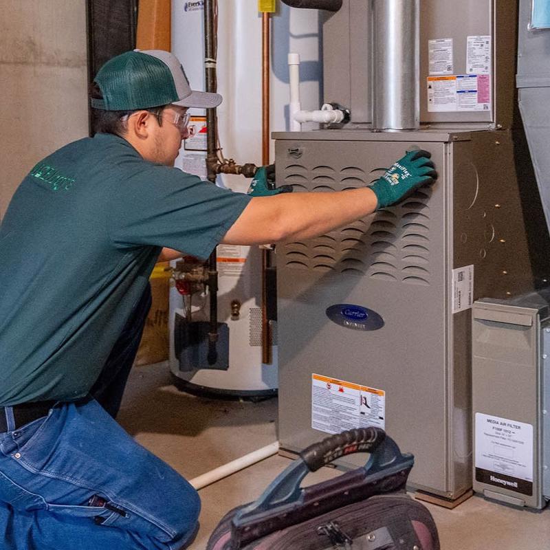 McElroy's residential HVAC technician closes up a new furnace.