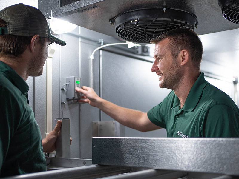 Brit Hunsicker, McElroy's Commercial HVAC Service Sales, discusses a project with Trevor Boudeman, McElroy's HVAC technician