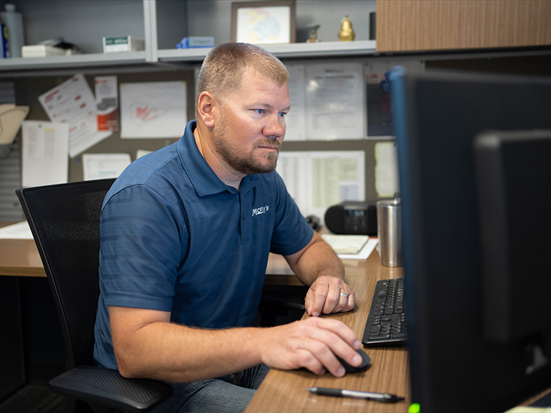 Jason Long, McElroy's Commercial HVAC Service Sales, confirms project information on his computer.