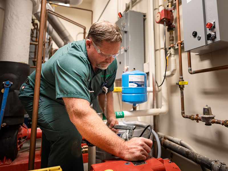 Brant Greenfield, McElroy’s commercial HVAC service technician, performs scheduled HVAC maintenance.