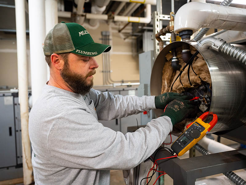 Brent Gordon fine tunes a boiler in the Tallgrass medical building’s mechanical room.