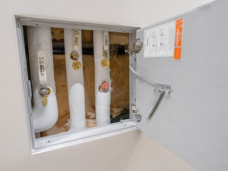 A locked panel provides secure access to water shutoff valves to reduce self-harm in behavioral healthcare settings.