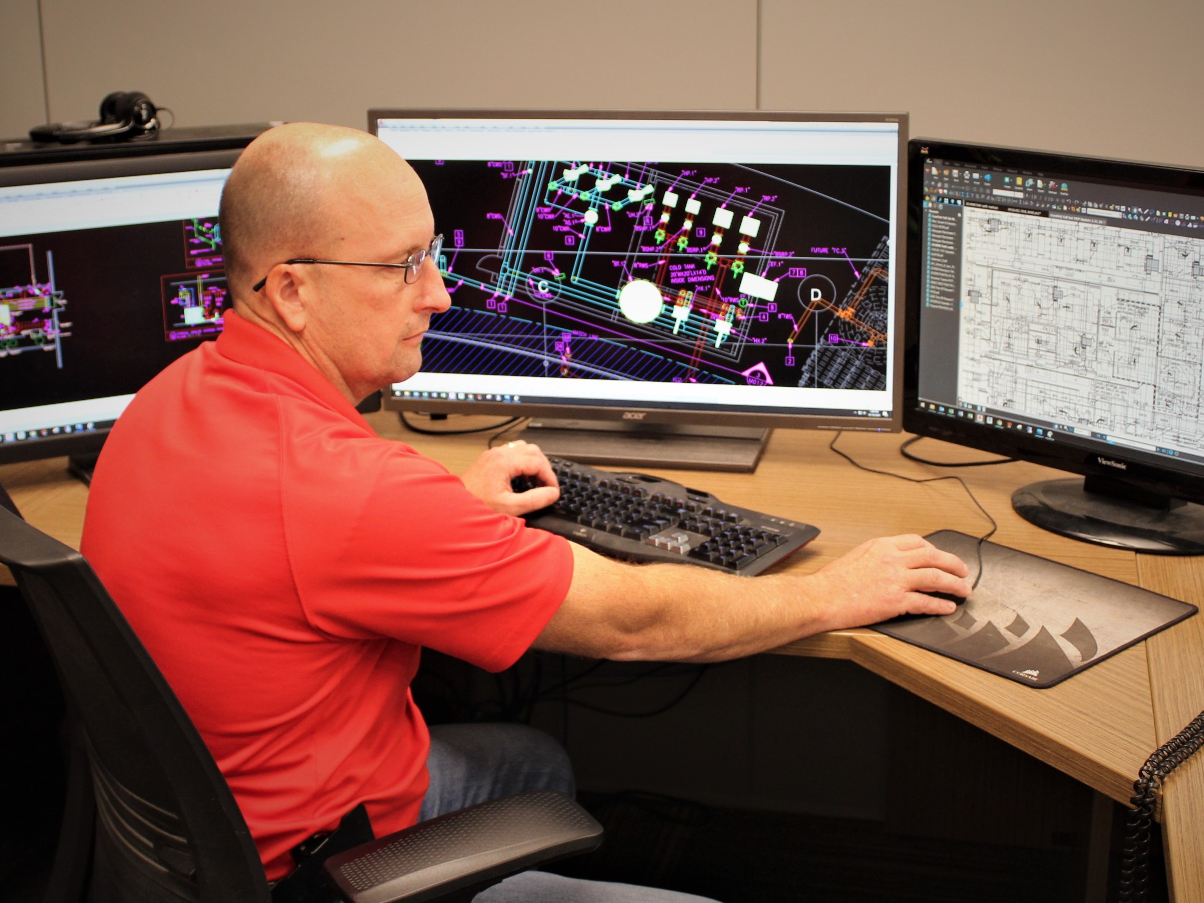 Wade Jueneman, one of McElroy's Inc.'s licensed engineers, works on the mechanical engineering design of a major industrial-facility project.
