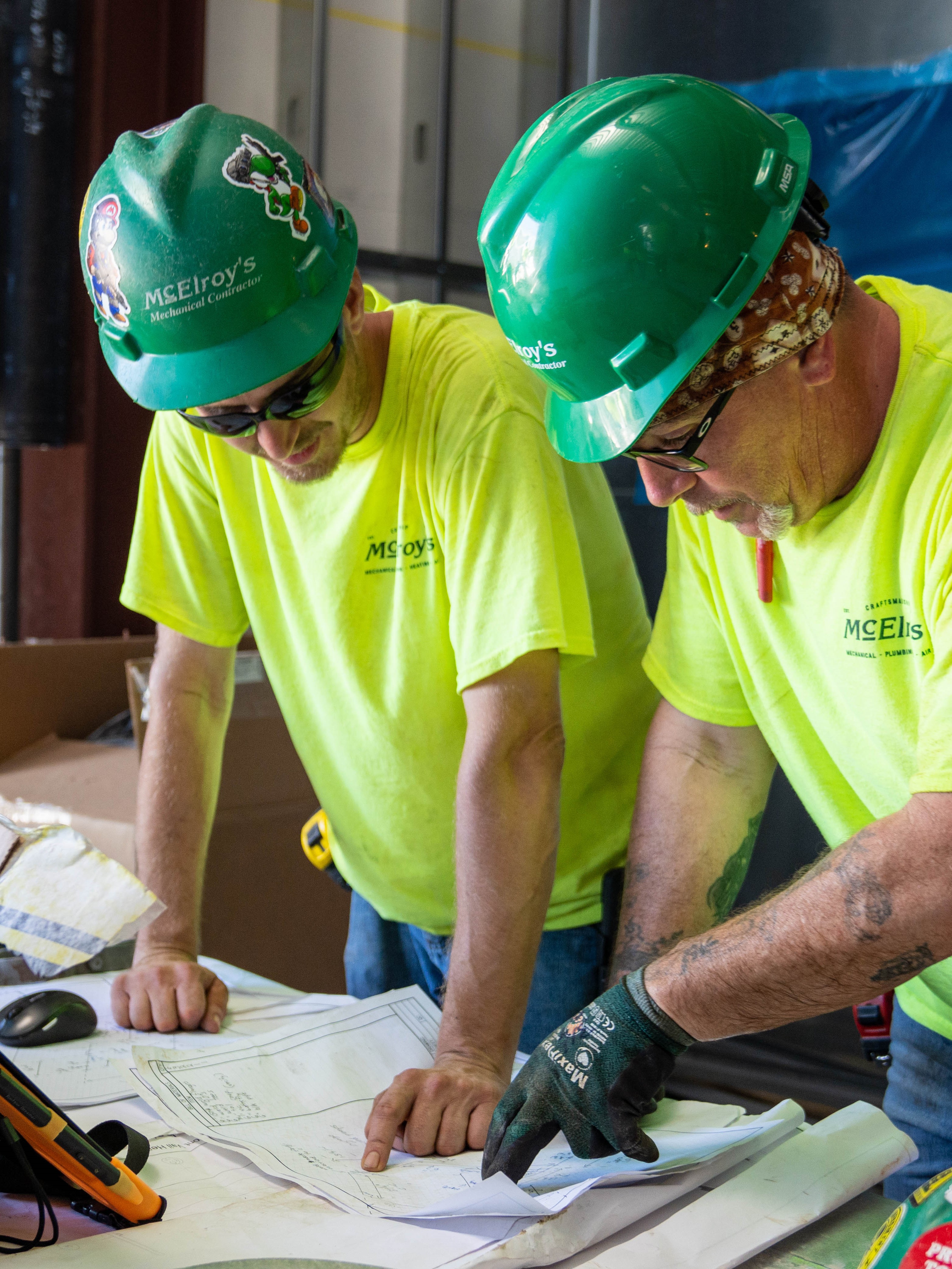 Brian Bergquist and Frank Huber review plans during construction of the Stormont Vail Health Manhattan Medical building.