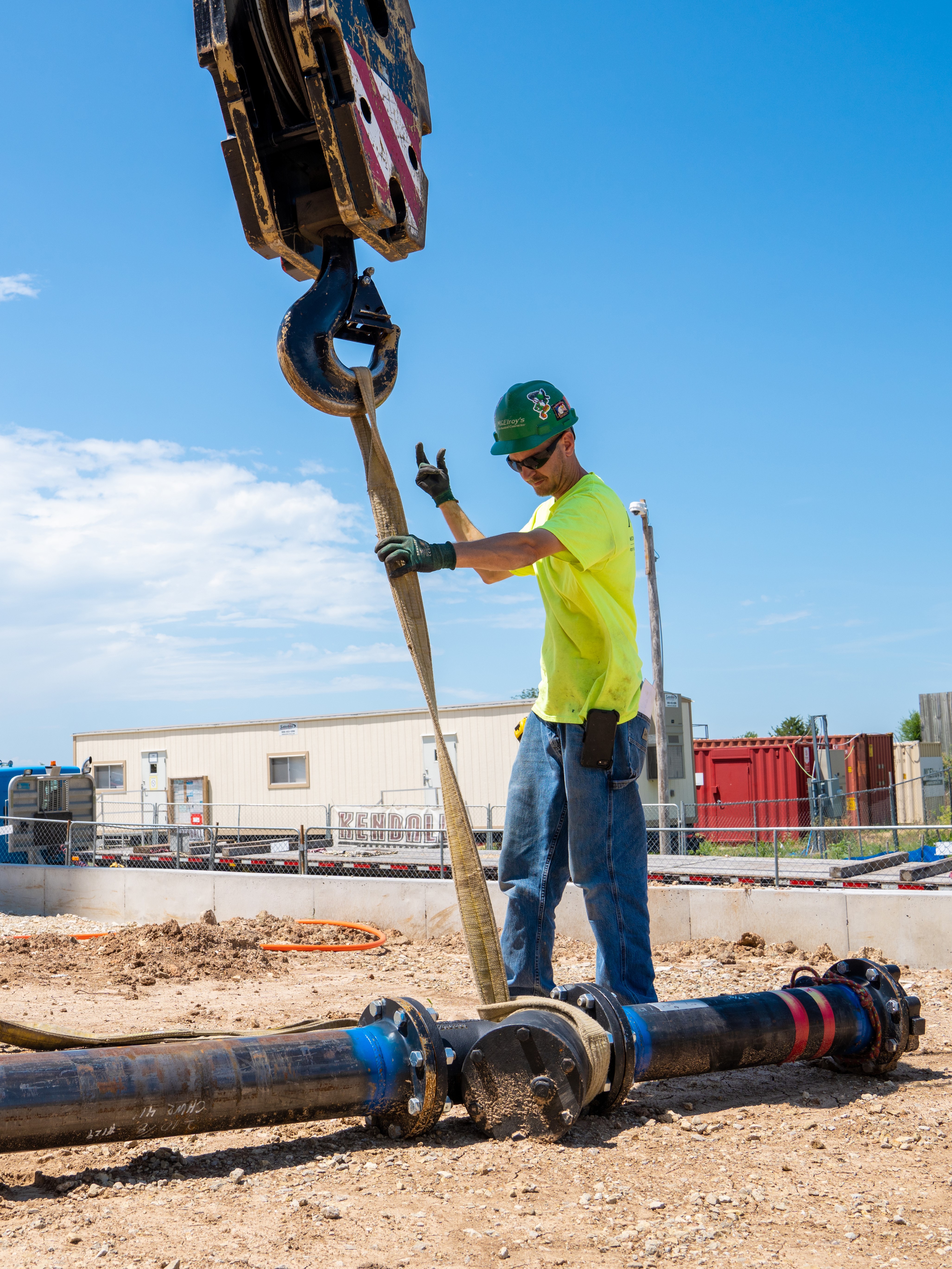 Brian Bergquist, McElroy’s commercial construction foreman, supervises crane lift of prefabricated pipe component.