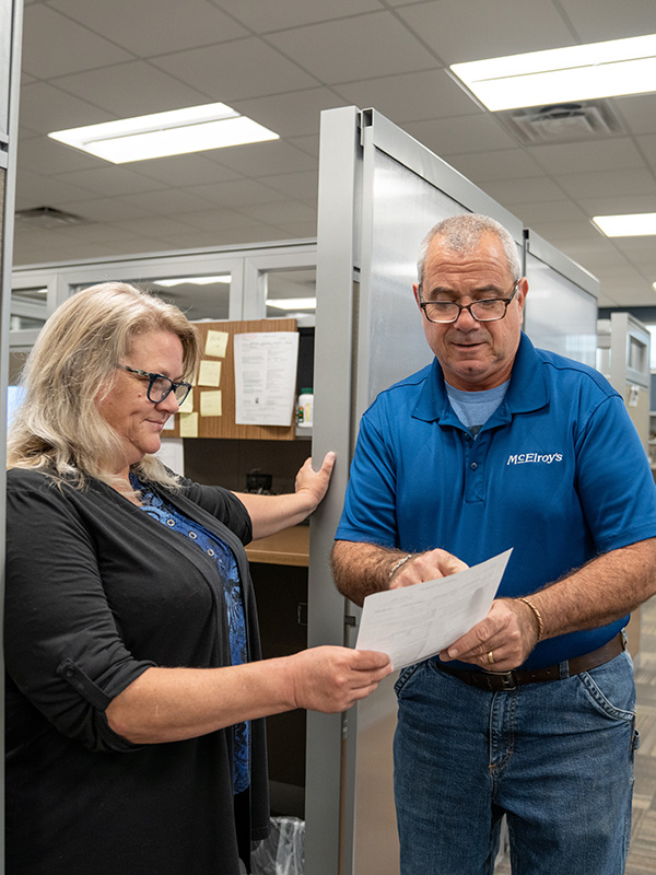 Julie Schirmer discusses HVAC customer service solutions with Haig Sarkesian, McElroy’s residential HVAC sales.