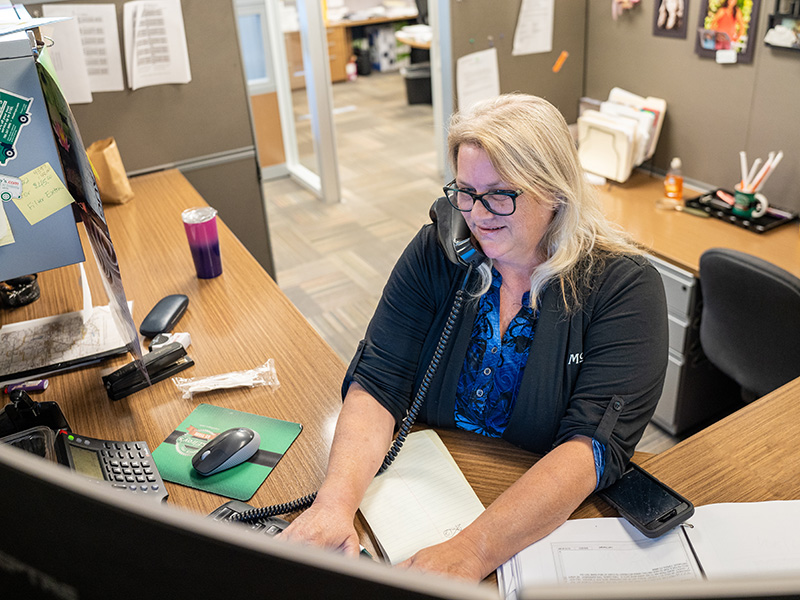 Julie Schirmer, McElroy’s HVAC service rep, smiles as she talks with customers on the phone so she’ll have a friendly voice.