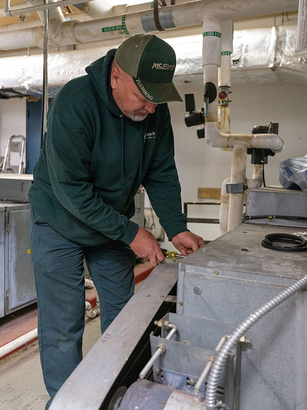 McElroy’s commercial HVAC service technician, Greg Zabokrtsky, removes a belt cover from an air-handler at Aldersgate Village.