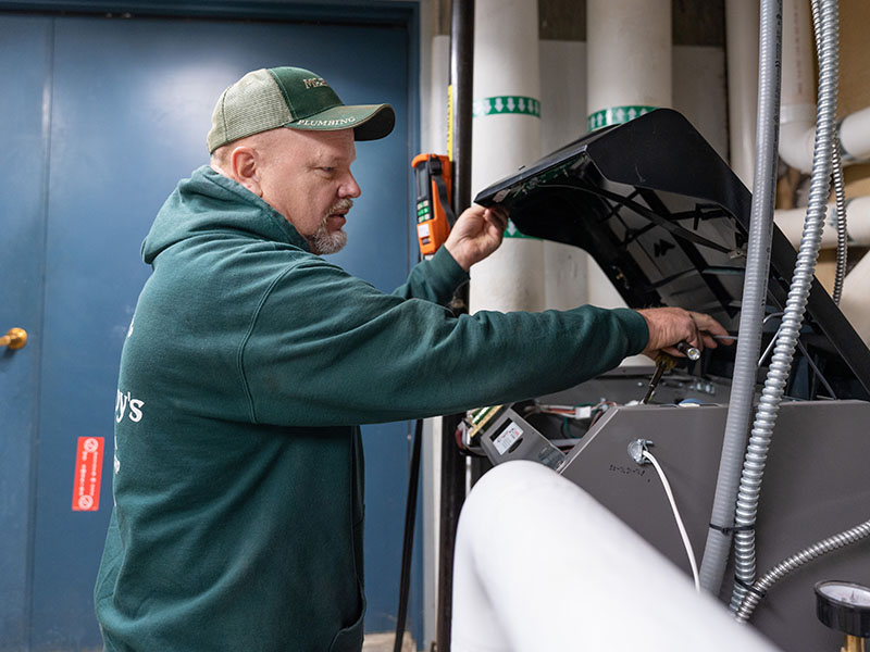 Greg Zabokrtsky, McElroy’s commercial HVAC service technician, performs maintenance on a boiler at Aldersgate Village.