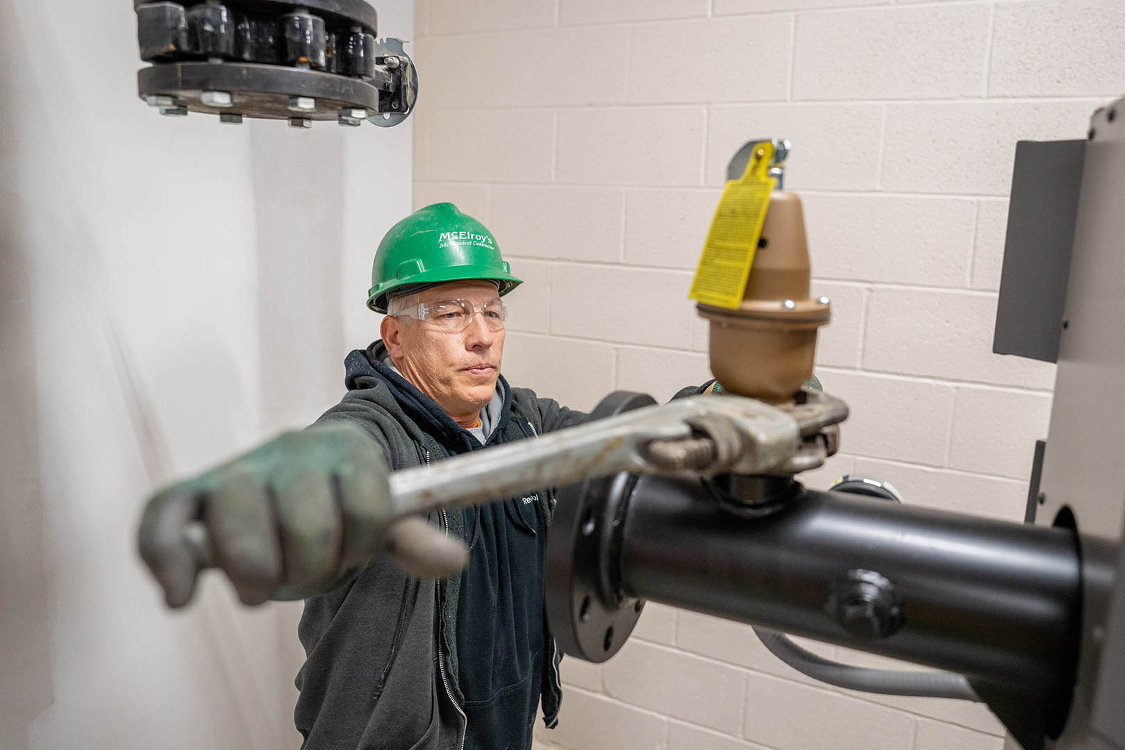 Jim Konrade of McElroy’s tightens a temperature/pressure relief fitting in a new medical facility’s hot-water system.