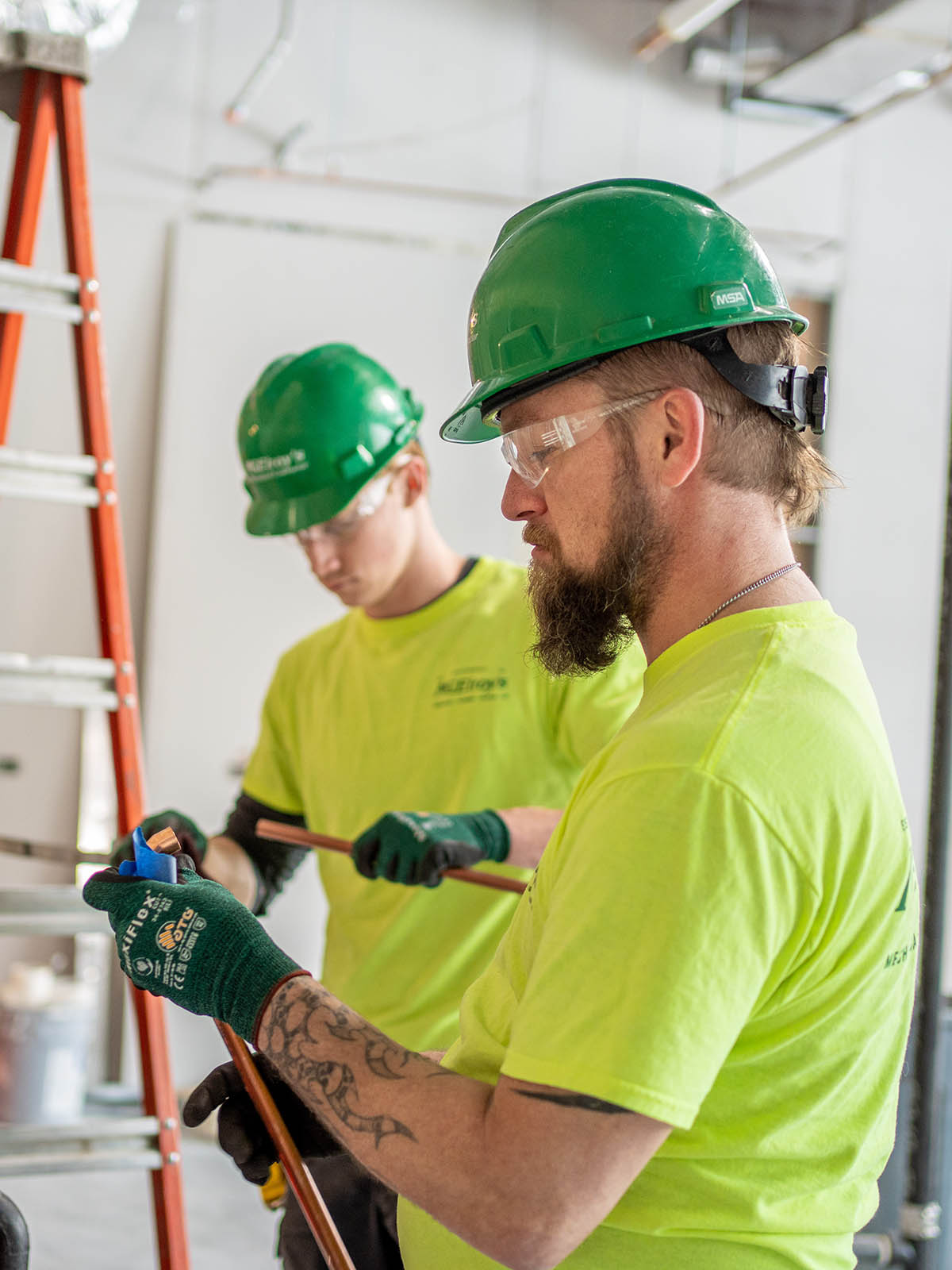 David Dwyer and Nate Fursman of McElroy’s prepare copper pipe for assembly in a new laboratory facility.