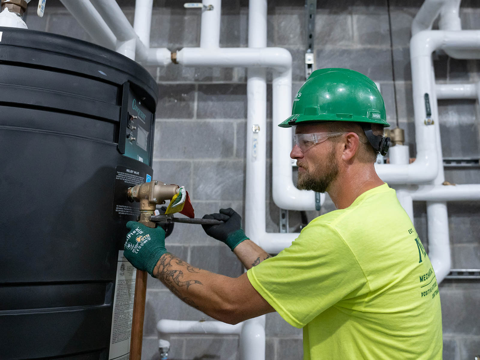 David Dwyer, McElroy’s plumbing/pipefitting foreman, works on a boiler connection in a new, Lawrence, Kansas medical facility.