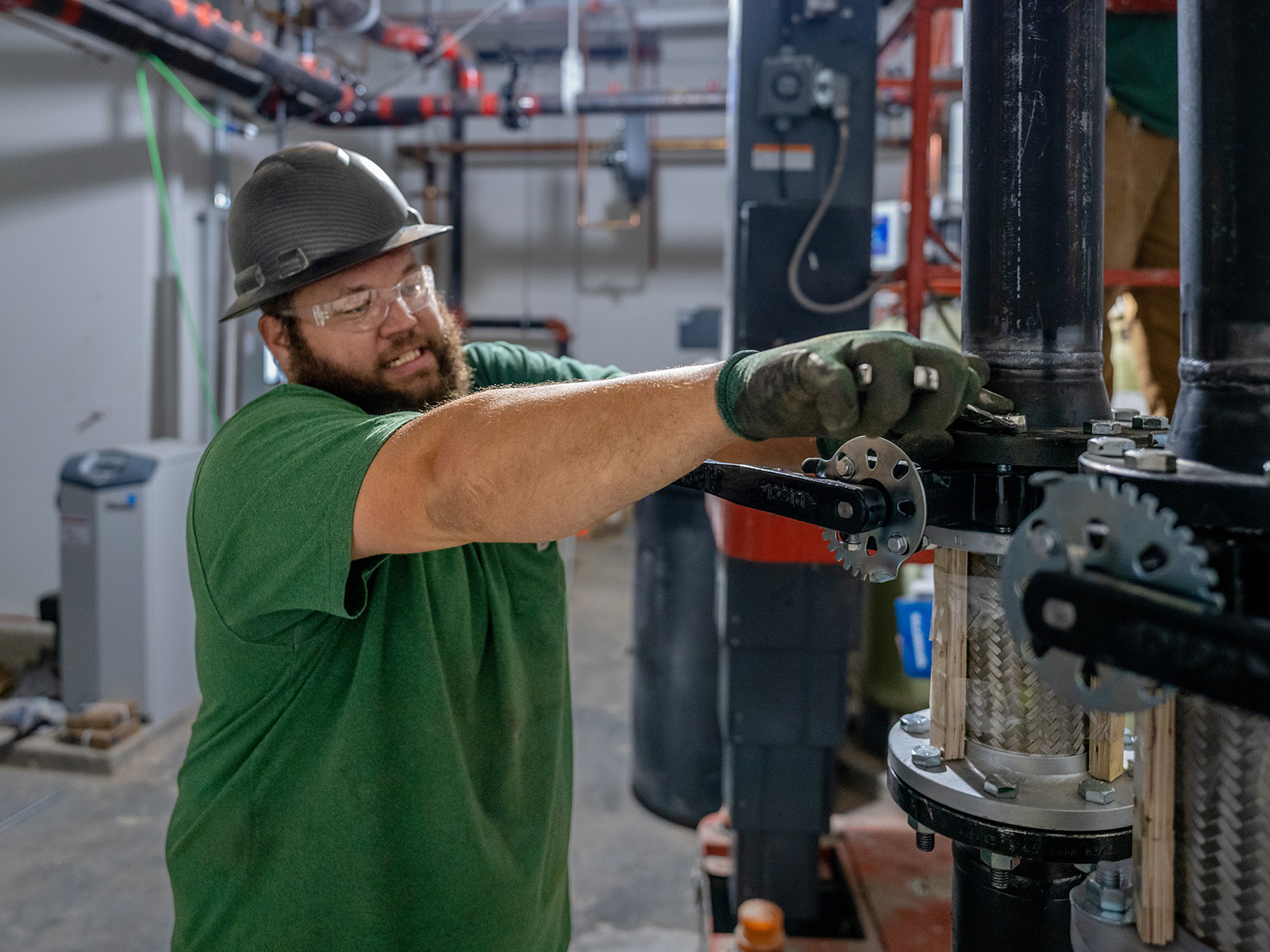 Chris Perkins, McElroy’s plumbing/pipefitting technician, constructs a piping system at Washburn University School of Law.