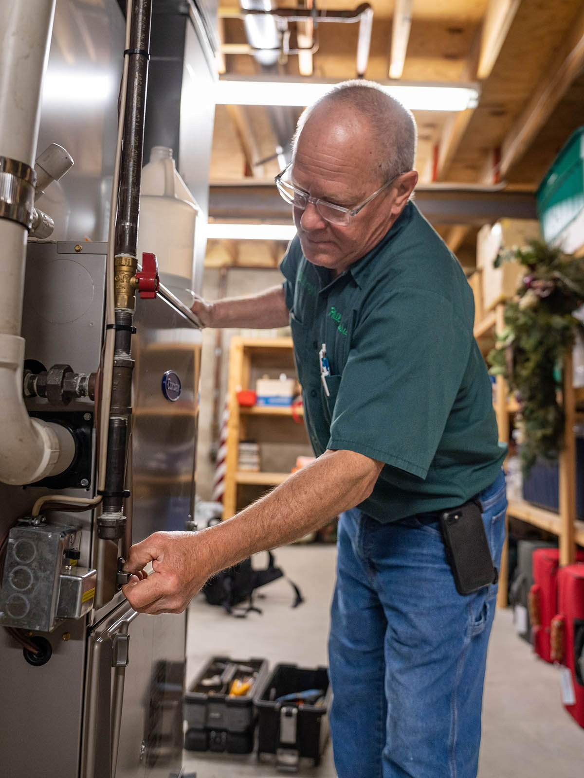 Phil Salsbury, McElroy’s residential HVAC technician, performs scheduled maintenance on a customer’s furnace.