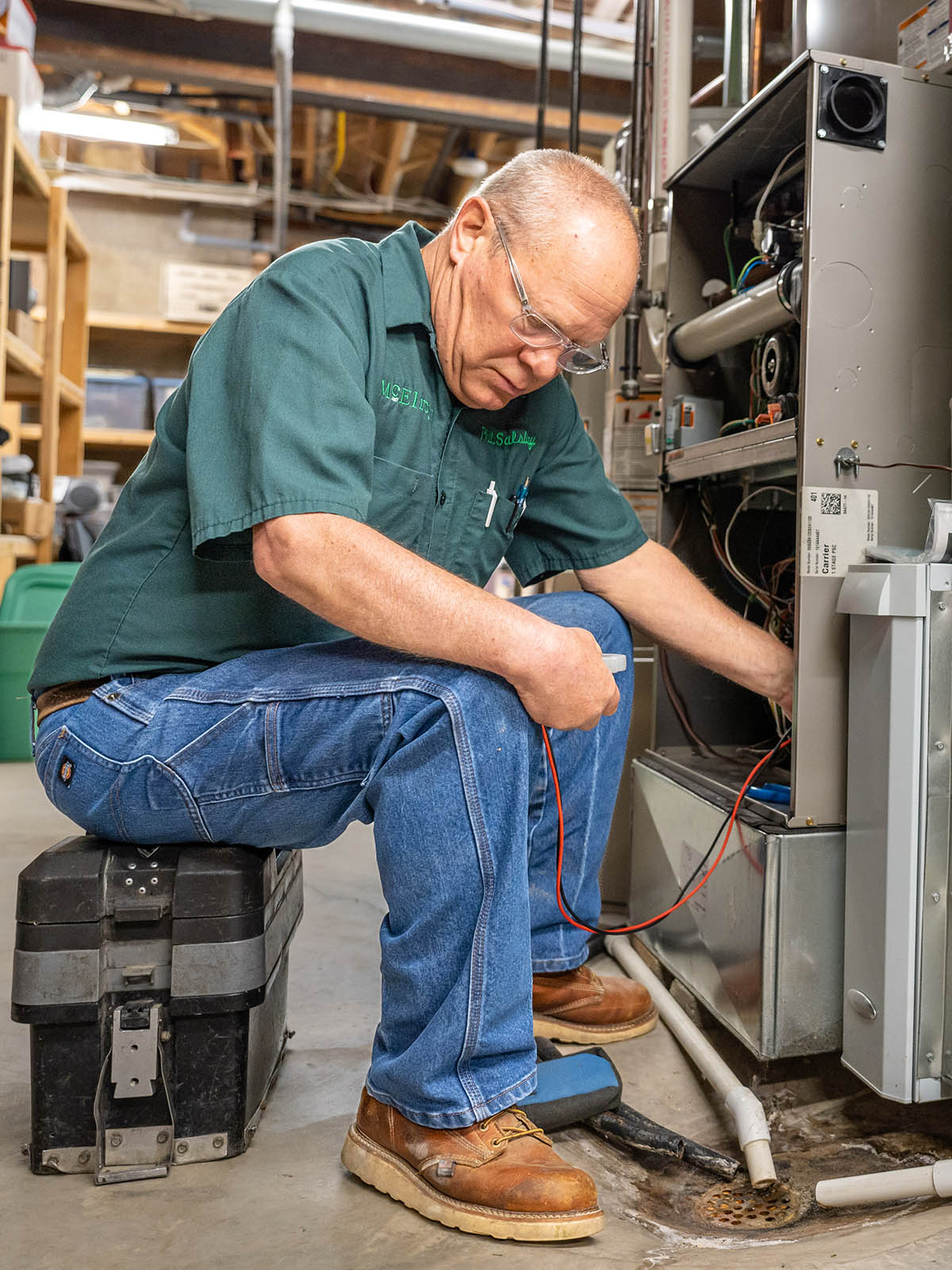 McElroy’s HVAC technician, Phil Salsbury, checks meter readings while working on a residential customer’s furnace.