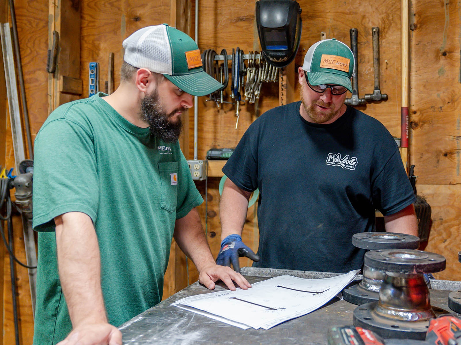 Joey Towle and Chris Morgan, McElroy’s plumber/pipefitter, review piping designs for fabrication in the McElroy’s shop.