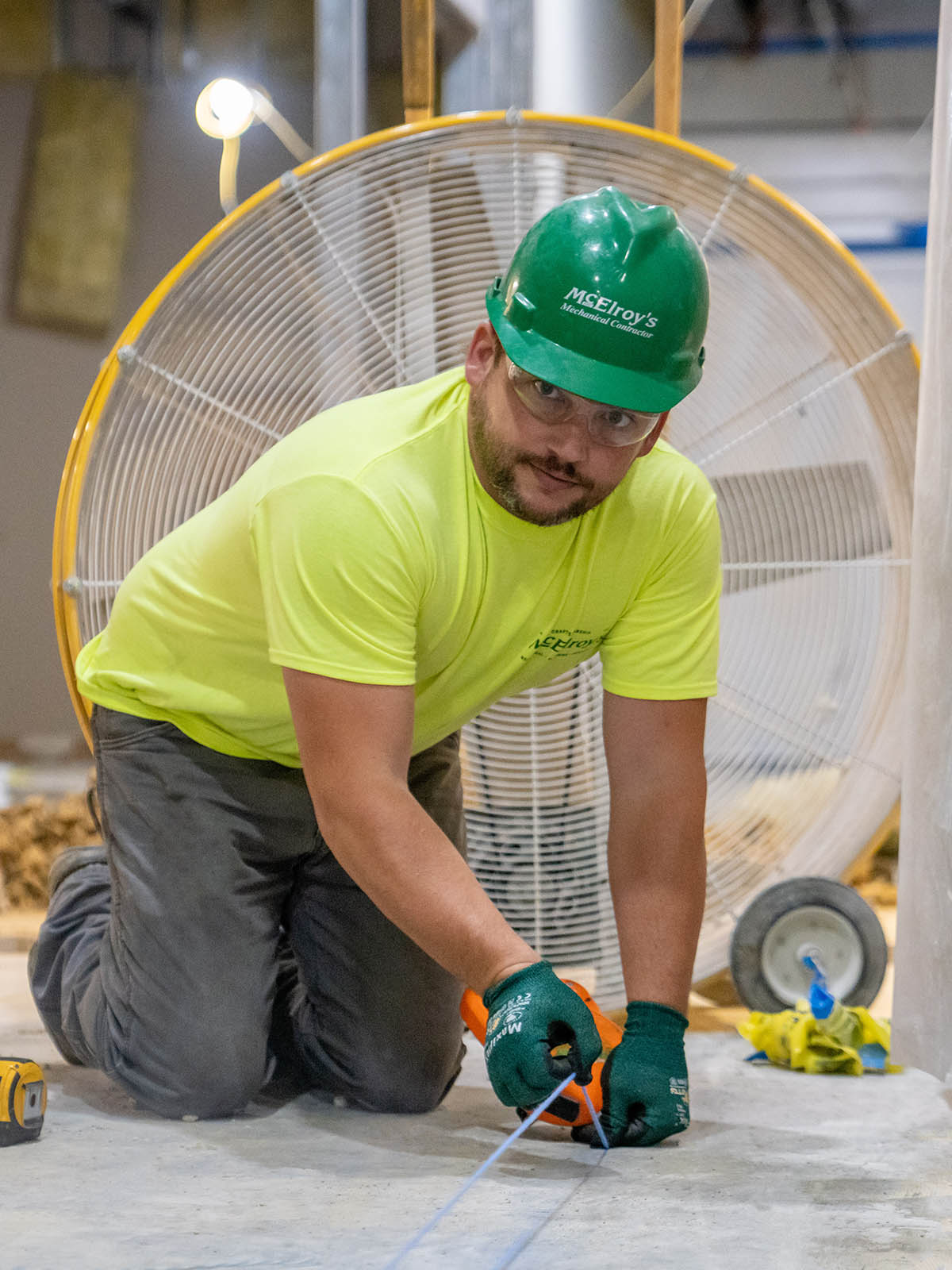 Chad Brucken, McElroy’s plumbing/pipefitting foreman, uses a chalk line to help with piping alignment.