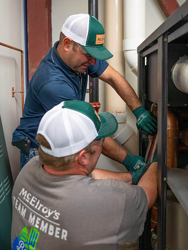 McElroy’s project supervisor, Phil Harper, and technician Brian Holle, work on replacement of a boiler.