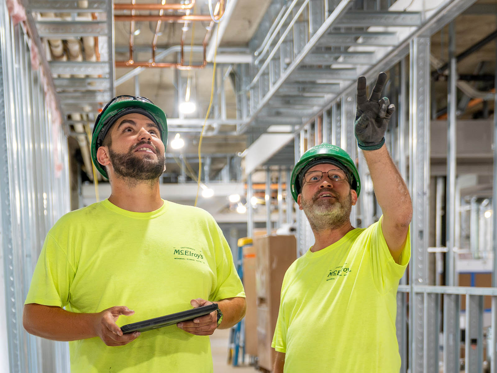 McElroy’s plumber/pipefitters, Hayden Selman and Shane Hillebert, inspect progress at the Brewster Place Senior Living Community.