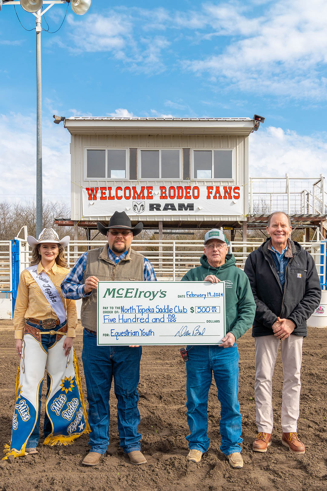 Gail Sage presents his $500 honorary donation to Jason Stoneking, president of North Topeka Saddle Club.