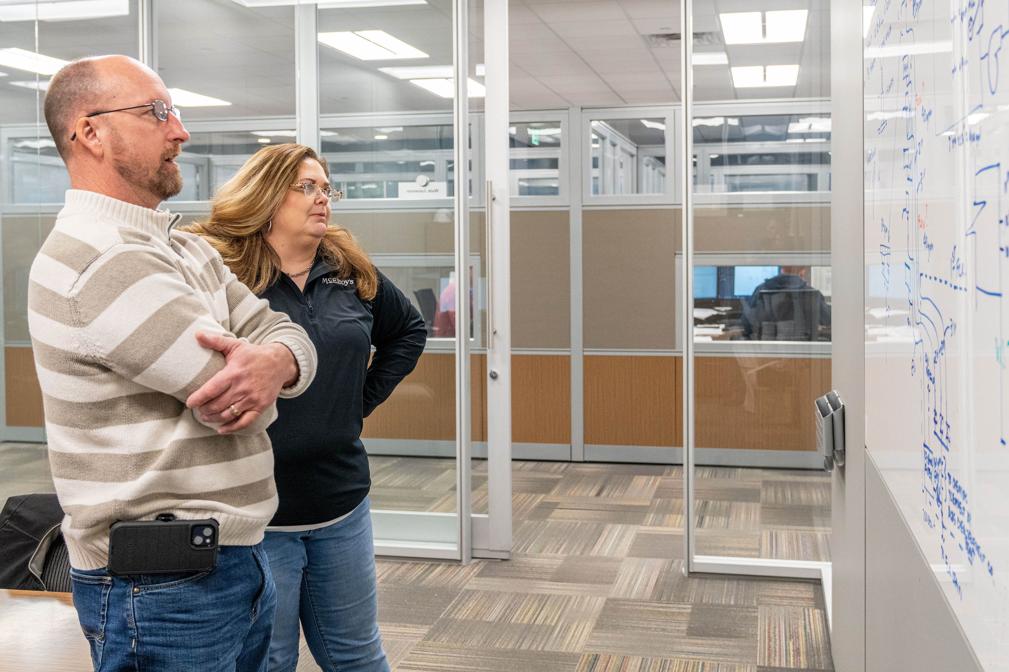 Kristen Colvin, McElroy’s commercial-construction assistant project manager, meets with Vice President Wade Jueneman.