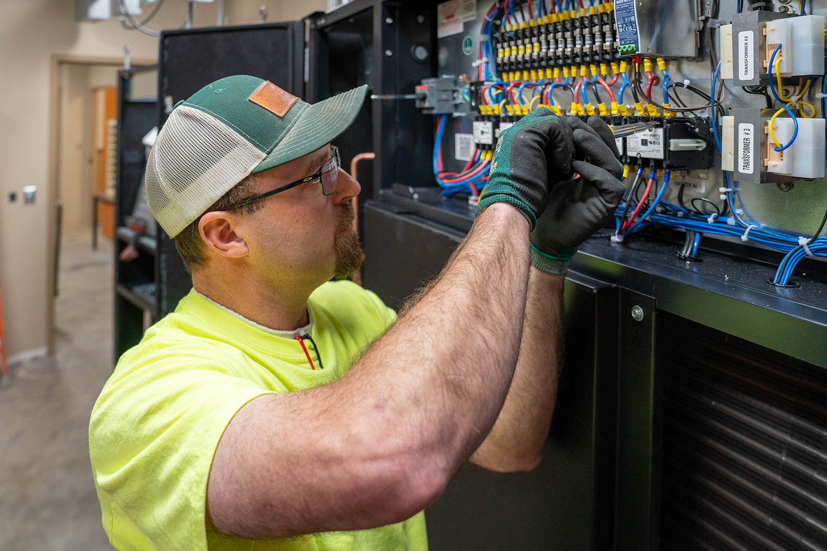 McElroy’s commercial-construction plumber/pipefitter, Kirk York, fine tunes components of a commercial HVAC system.