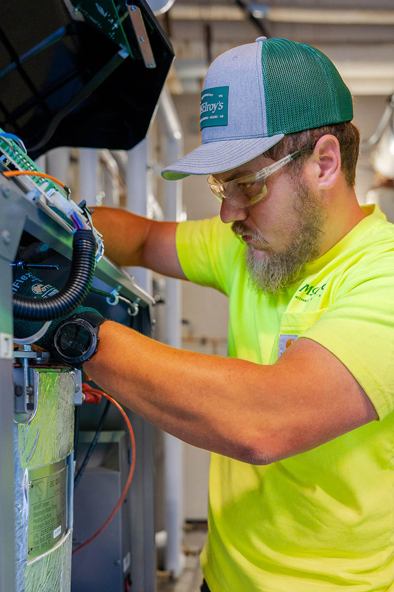 McElroy’s commercial HVAC service technician, Bobby Millard, does maintenance on a boiler system for a high school kitchen.