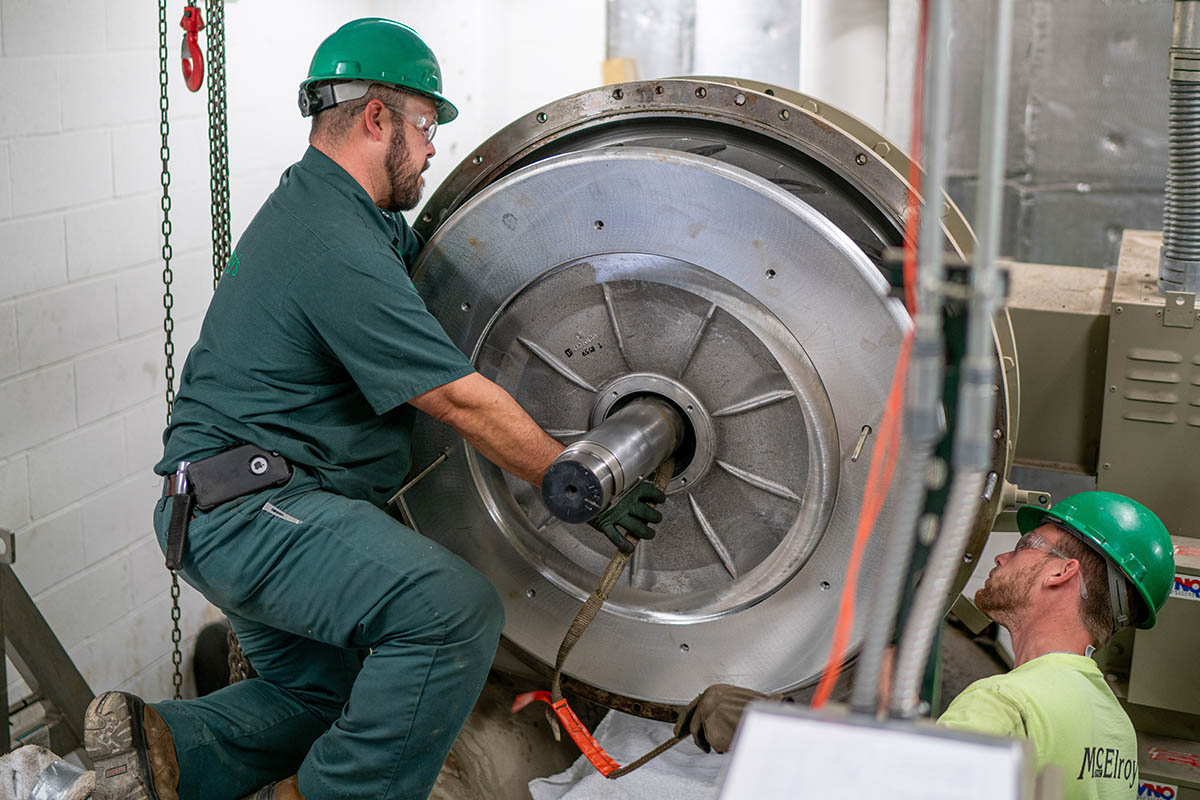 Corey Keller and Dylan Huninghake, McElroy’s commercial HVAC service technicians, overhaul a large centrifugal chiller.