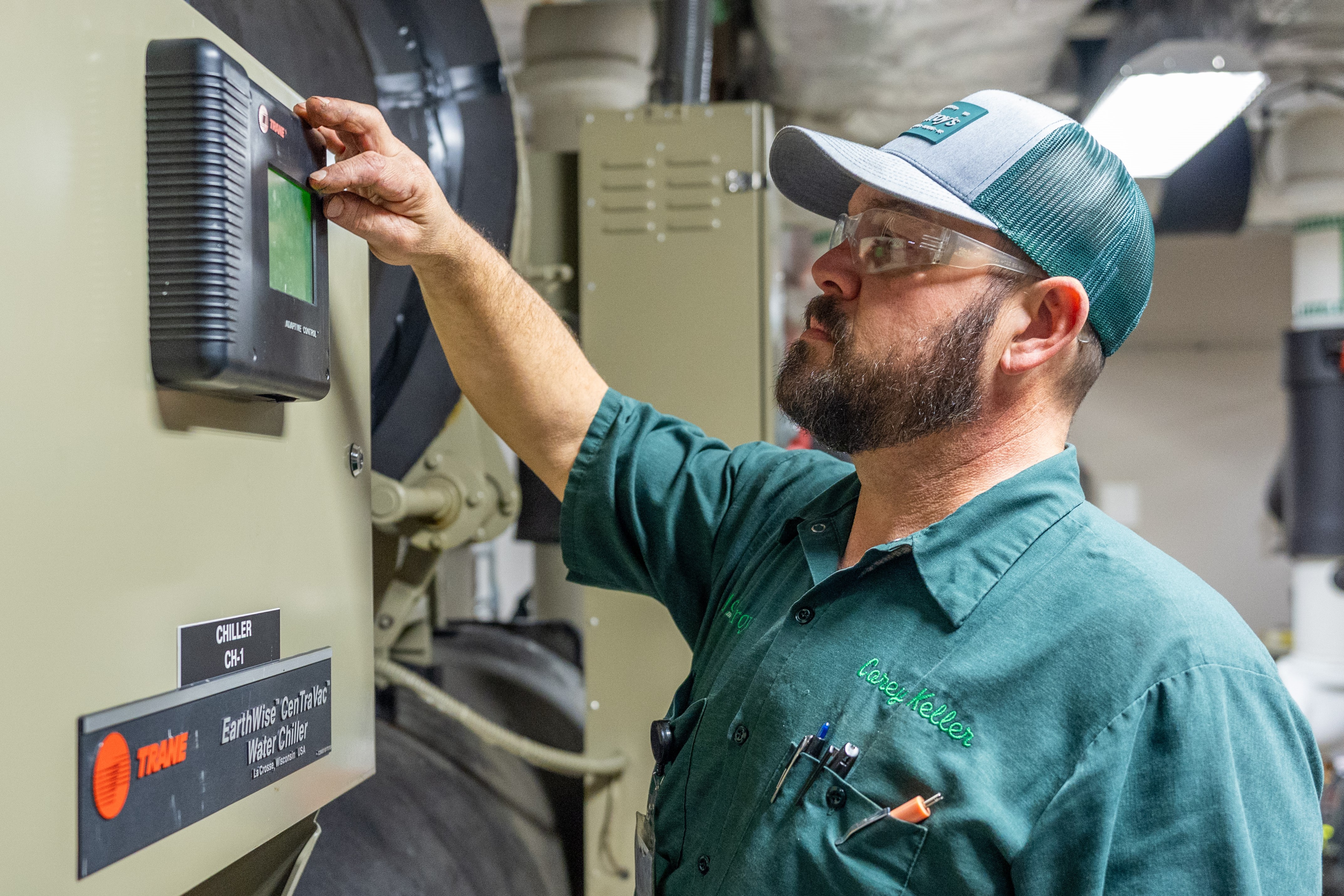 Corey Keller, McElroy’s commercial HVAC service technician, adjusts building automation controls.