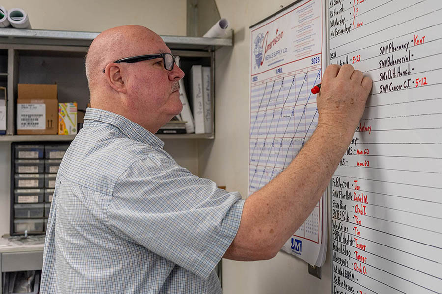 Martin Decker, Jr., McElroy’s sheet metal manager, organizes manpower scheduling for commercial construction projects.