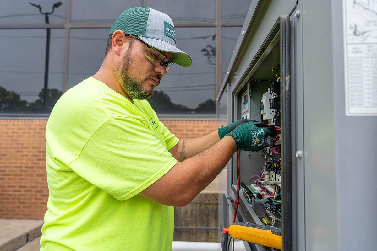 Shawn Brown, McElroy’s commercial HVAC service technician, runs diagnostics on a commercial HVAC system.