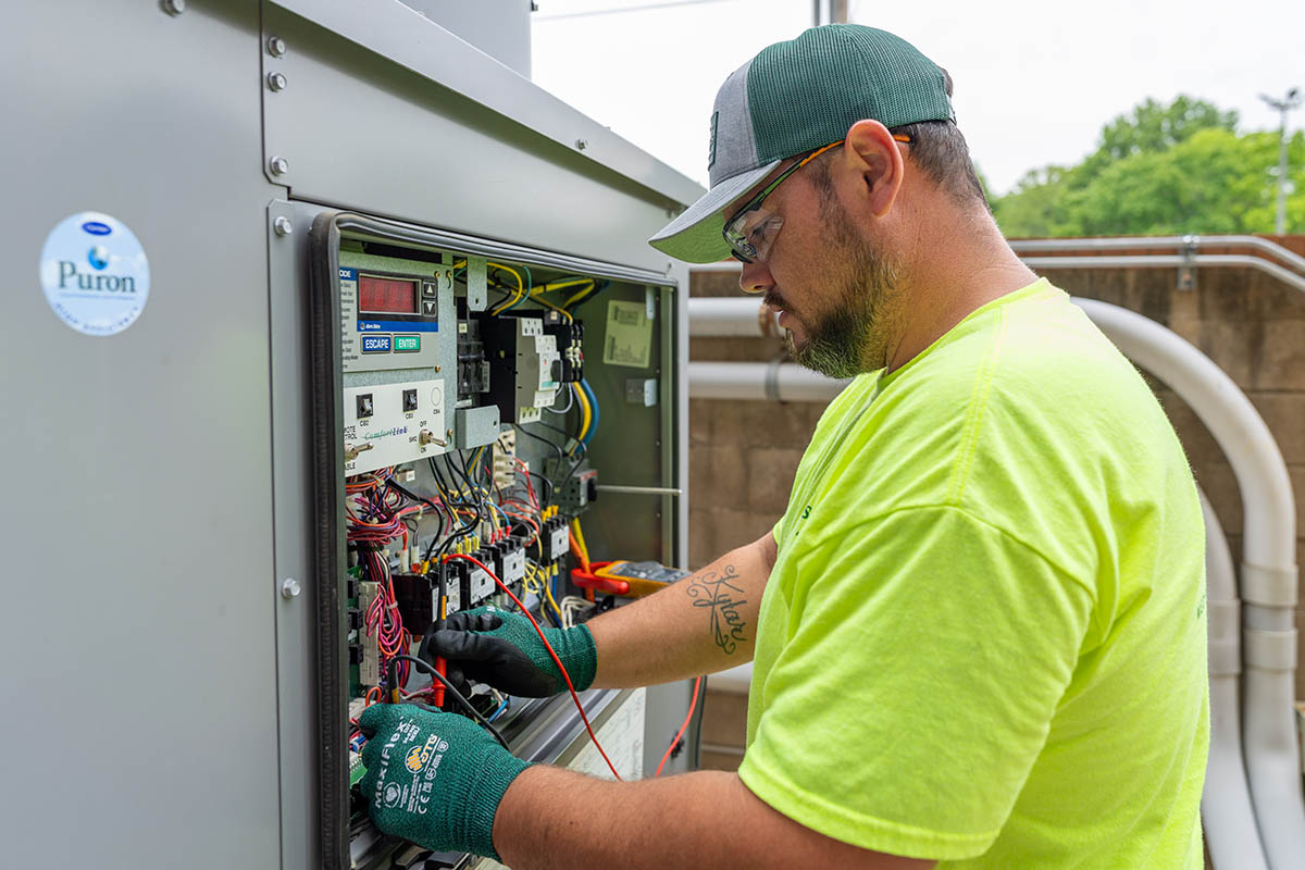 Shawn Brown, McElroy’s commercial HVAC service technician, fine tunes the operation of a commercial HVAC system.