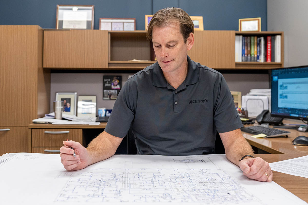 Richard Hammer, McElroy’s commercial project engineer/manager, reviews the plans for a major construction project.
