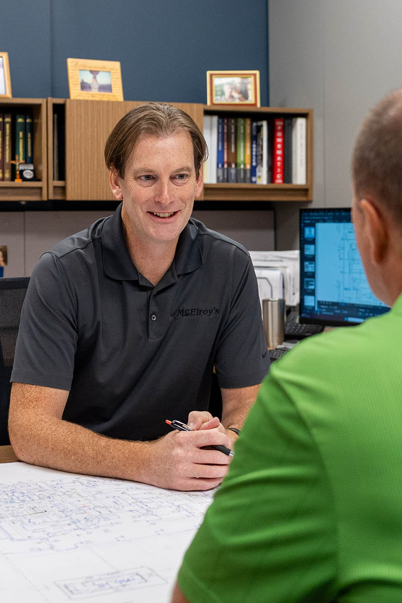 Richard Hammer, McElroy’s commercial project engineer/manager, meets with Wade Jueneman, McElroy’s president and leader of the commercial construction team.