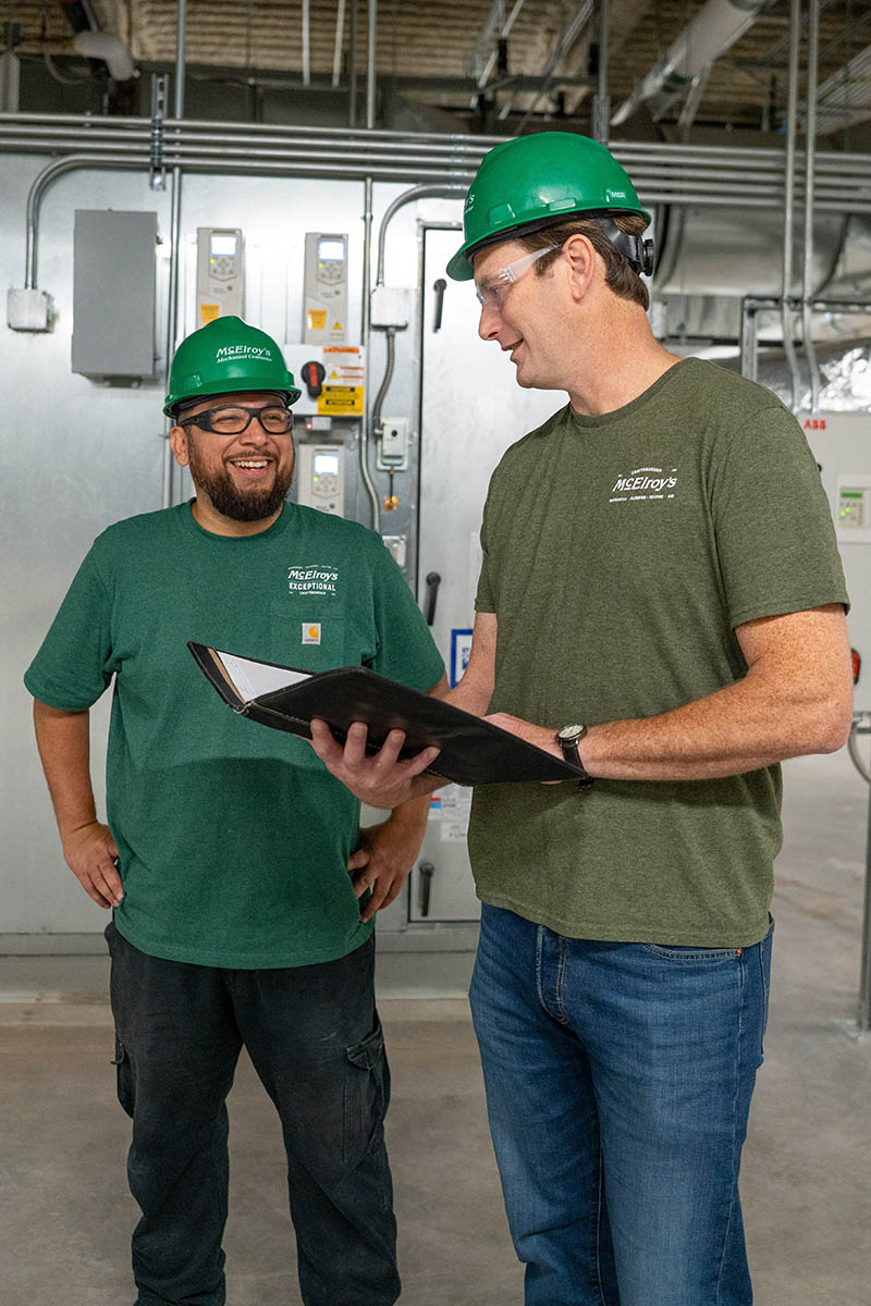 Richard Hammer, McElroy’s commercial project engineer/manager, meets on a jobsite with Chuck Mercado, McElroy’s sheet metal foreman.